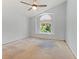 Bright bedroom featuring a vaulted ceiling, large arched window, ceiling fan, and neutral walls at 2068 Diane Ave, Palm Harbor, FL 34683