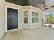 Cozy front porch featuring a ceiling fan, view to the kitchen and an inviting entrance at 2068 Diane Ave, Palm Harbor, FL 34683