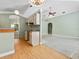Eat-in kitchen featuring wood laminate flooring and views into the living room and dining area at 2068 Diane Ave, Palm Harbor, FL 34683