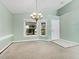 Inviting space with a charming chandelier and plenty of natural light from double windows at 2068 Diane Ave, Palm Harbor, FL 34683