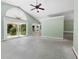 Bright living room featuring vaulted ceilings, sliding glass doors, and large windows with exterior views at 2068 Diane Ave, Palm Harbor, FL 34683