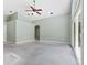 Spacious living room with neutral walls, ceiling fan, and sliding doors at 2068 Diane Ave, Palm Harbor, FL 34683