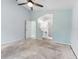 Spacious main bedroom featuring a ceiling fan, leading to bathroom vanity and closet at 2068 Diane Ave, Palm Harbor, FL 34683