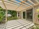 Outdoor patio area featuring pergola and sliding glass doors at 2068 Diane Ave, Palm Harbor, FL 34683
