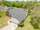 Overhead shot displays the house with a screened pool, a large backyard, and well-manicured landscaping at 2141 Coachman Rd, Spring Hill, FL 34608