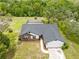 Aerial view of the home featuring well-maintained landscaping, a screened pool, and a spacious driveway at 2141 Coachman Rd, Spring Hill, FL 34608