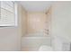 Clean bathroom featuring a tiled shower, tub, and a toilet at 2141 Coachman Rd, Spring Hill, FL 34608