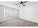 Bedroom with large window and plush carpet, perfect for relaxation at 2141 Coachman Rd, Spring Hill, FL 34608