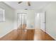 Bedroom with hardwood floors, ceiling fan, closet with mirrored doors, and ensuite bathroom at 2141 Coachman Rd, Spring Hill, FL 34608