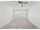 Bright bedroom featuring a bay window and plush carpet at 2141 Coachman Rd, Spring Hill, FL 34608