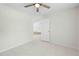 Spacious bedroom with tiled floor, open door, and light, airy feel at 2141 Coachman Rd, Spring Hill, FL 34608