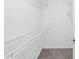 Walk in closet with carpet flooring and shelving at 2141 Coachman Rd, Spring Hill, FL 34608