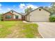 Charming single-story home featuring a 2 car garage and well-manicured front yard at 2141 Coachman Rd, Spring Hill, FL 34608