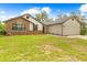 Charming single-Gathering home with a mix of brick and white siding, and a well-maintained lawn at 2141 Coachman Rd, Spring Hill, FL 34608