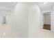 Hallway with neutral walls and tile flooring leading to other rooms in the home at 2141 Coachman Rd, Spring Hill, FL 34608