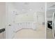 Open kitchen with white cabinetry, stainless steel appliances, and tile floors at 2141 Coachman Rd, Spring Hill, FL 34608