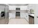 Updated kitchen featuring white cabinets, stainless steel appliances, and tile flooring at 2141 Coachman Rd, Spring Hill, FL 34608