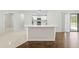Open-concept living area featuring bar top and views of the kitchen and outdoor pool at 2141 Coachman Rd, Spring Hill, FL 34608