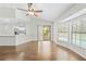 Bright living area features wood floors, natural light, and access to the outdoor pool at 2141 Coachman Rd, Spring Hill, FL 34608