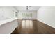 Bright living room with wood floors and a large bay window overlooking the front yard at 2141 Coachman Rd, Spring Hill, FL 34608