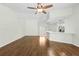 Spacious living area with wood floors, a ceiling fan, and plenty of natural light at 2141 Coachman Rd, Spring Hill, FL 34608