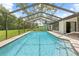 Pool and patio view with screen enclosure at 2141 Coachman Rd, Spring Hill, FL 34608
