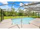 Beautiful in-ground screened-in pool with a sunny patio area at 2141 Coachman Rd, Spring Hill, FL 34608