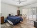 Comfortable bedroom with a large window, wood floors, and simple furnishings at 2199 Blue Tern Dr, Palm Harbor, FL 34683