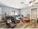 Cozy living room featuring ample natural light, hardwood floors, and comfortable furnishings at 2199 Blue Tern Dr, Palm Harbor, FL 34683