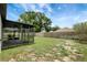 Spacious backyard with lawn, screened porch and a wooden privacy fence at 22824 Marsh Wren Dr, Land O Lakes, FL 34639