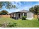 Backyard with a screened-in porch and privacy fence, perfect for relaxing outdoors at 22824 Marsh Wren Dr, Land O Lakes, FL 34639