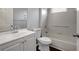 Bathroom featuring a white vanity, toilet, and a bathtub with tile surround at 22824 Marsh Wren Dr, Land O Lakes, FL 34639