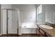Bright bathroom featuring a soaking tub, separate glass shower, and wood look floors at 22824 Marsh Wren Dr, Land O Lakes, FL 34639