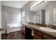 Spacious bathroom with a double sink vanity, soaking tub, and glass enclosed shower at 22824 Marsh Wren Dr, Land O Lakes, FL 34639