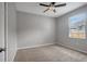 Cozy bedroom featuring neutral walls, carpet flooring, and a ceiling fan for optimal comfort at 22824 Marsh Wren Dr, Land O Lakes, FL 34639