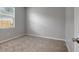 Carpeted bedroom with a window and neutral paint, offering a serene atmosphere at 22824 Marsh Wren Dr, Land O Lakes, FL 34639