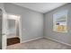 Inviting bedroom with wood look floors in the entryway and a large window at 22824 Marsh Wren Dr, Land O Lakes, FL 34639