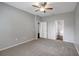 Large carpeted bedroom with a ceiling fan and doorways to other rooms at 22824 Marsh Wren Dr, Land O Lakes, FL 34639