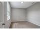 Carpeted bedroom featuring neutral paint, window and sufficient space at 22824 Marsh Wren Dr, Land O Lakes, FL 34639