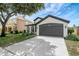 Charming home featuring a two-car garage and well-manicured landscaping at 22824 Marsh Wren Dr, Land O Lakes, FL 34639