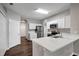 Kitchen featuring white cabinets, stainless appliances, quartz countertop, and wood-look floors at 22824 Marsh Wren Dr, Land O Lakes, FL 34639