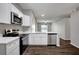 Bright kitchen with stainless appliances, white cabinets, quartz countertops, and wood-look flooring at 22824 Marsh Wren Dr, Land O Lakes, FL 34639
