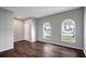 The living room features two arched windows, neutral walls, and wood-look flooring at 22824 Marsh Wren Dr, Land O Lakes, FL 34639