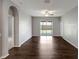 Spacious living room with wood-look floors and sliding glass doors leading to the outdoor patio at 22824 Marsh Wren Dr, Land O Lakes, FL 34639