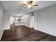 Spacious living room with wood-look flooring leading to the kitchen and hallway at 22824 Marsh Wren Dr, Land O Lakes, FL 34639