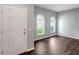 The living room features a front door, hardwood floors and arched windows that stream in natural light at 22824 Marsh Wren Dr, Land O Lakes, FL 34639