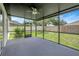 Covered screened porch offers a serene outdoor living space with views of the backyard at 22824 Marsh Wren Dr, Land O Lakes, FL 34639