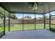 Relaxing screened porch with ceiling fan providing peaceful outdoor living space at 22824 Marsh Wren Dr, Land O Lakes, FL 34639