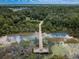 Stunning aerial view of wooden pier and lake surrounded by lush green trees and natural landscape at 2455 Anthony Ave, Clearwater, FL 33759