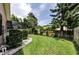 Well-manicured backyard with lush green grass and meticulously maintained landscaping at 2455 Anthony Ave, Clearwater, FL 33759